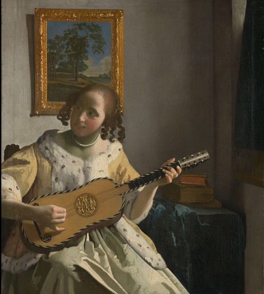 Girl in yellow dress playing guitar.
